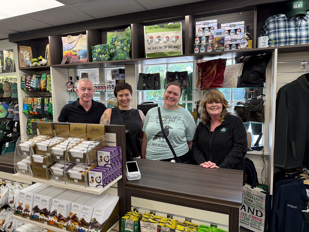 Erin gift store people standing behind a counter in a store with shelves and products in the background
